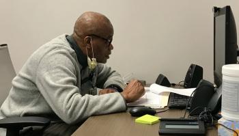 Therapist Charles Brown leading a group session through videoconferencing